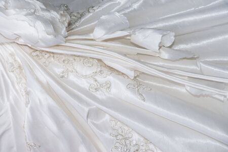embroidered white wedding dress close up backgroundの写真素材