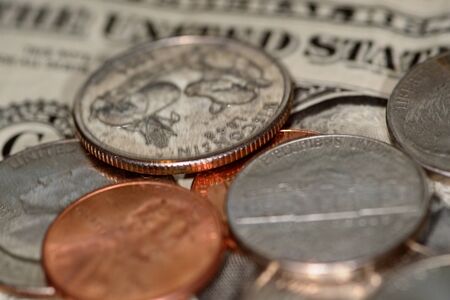 selective focus close up shot of assorted us banknotes and coins