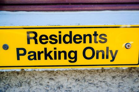 Residents only parking sign on wall in UK