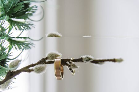 wedding rings and flowers and branches close up before the ceremony