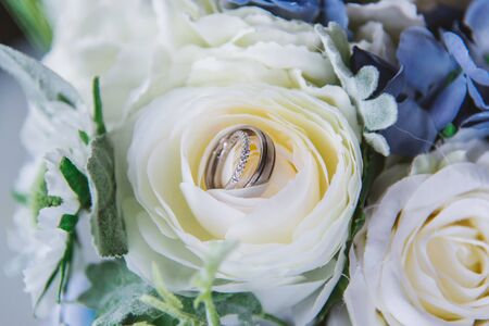 wedding rings and flowers and branches close up before the ceremonyの写真素材
