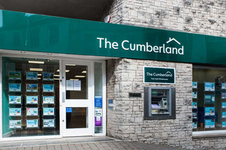 Cumberland Building Society sign above the entrance to a branch in high street setting. UKのeditorial素材