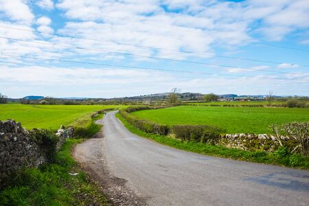 Mother and choildren walk on country rural roadの写真素材