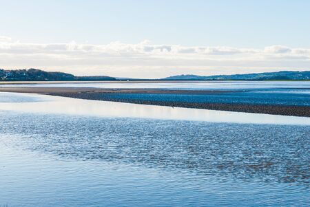 Estuary with Arnside viaduct in background Sandside, Cumbria UKの写真素材