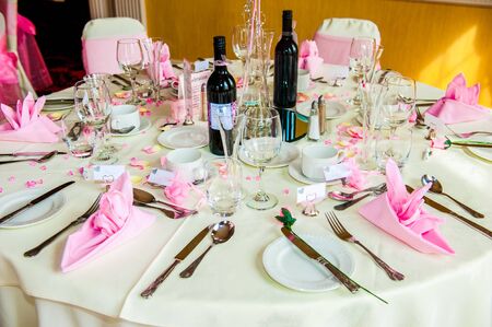 Table set for a Wedding reception with bottles of wine UKの写真素材