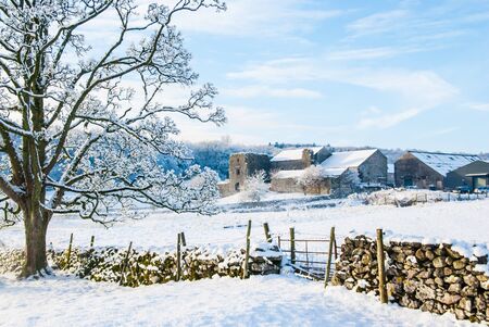 Beetham Hall on a snowey Winters day with dry stone wall and gate in foreground UKの写真素材