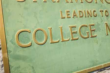 College sign in green with brass letters UKの写真素材