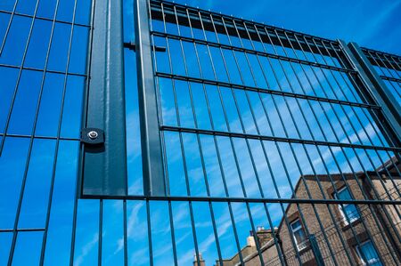 Black metal security gates protecting business propertyの写真素材