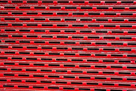 Rusty,red peeling building shutters background.の写真素材