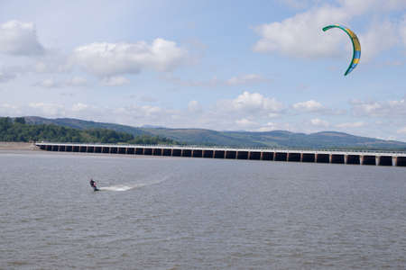 Arnside UK 24 May 2020 Kite Surfer and Railway viaduct at Arnside on a very windy dayのeditorial素材
