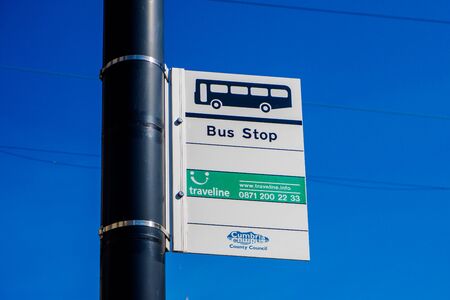 Bus Stop Sign with lovely blue sky behind UKの写真素材