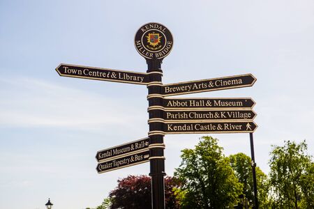 Town signpost showing directions to various places in the center of historical town Kendal. Kendal is considered as the southern gateway to the Lake District, UKの写真素材