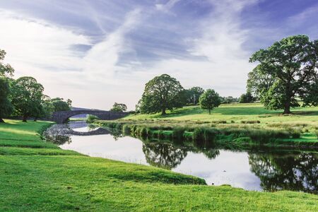 Bridge in Dallam Park, Milnthorpe, Cumbria passing over the river Belaの写真素材