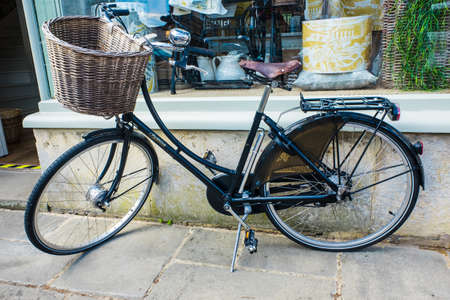 Old bicycle leaning against a shop doorwayのeditorial素材