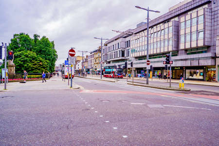 People are walking down the Princes street in Edinburgh, Scotland, UK