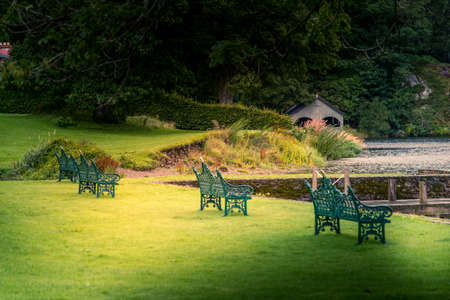 Empty benches on the shore of lake ullswater with beautiful view of the lake's north coastの写真素材