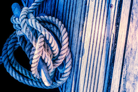 close up of yacht mooring rope tied around cleat in harbourの写真素材