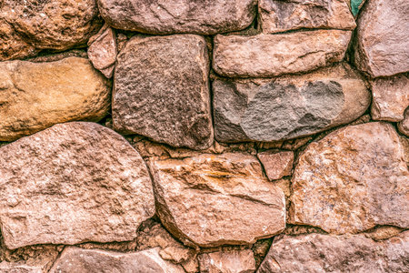 Close up of old stone wall with ancient stonework.の写真素材
