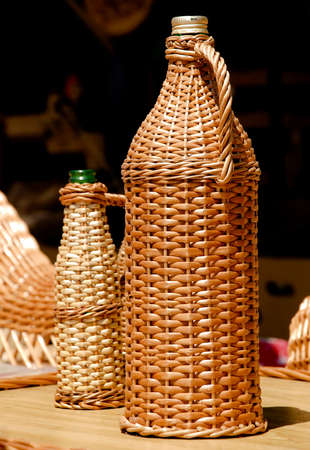 Close composition of two glass Bottle covered with osierの写真素材