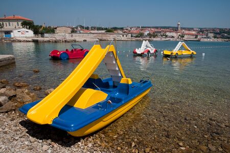 Blue and yellow pedalo boat on seaside at Krk - Croatiaの写真素材