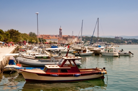 Ships and boats docked at Krk city Port - Croatiaの写真素材
