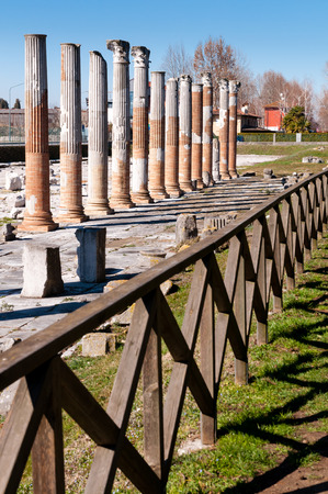 Columns and fence on Archeological area of Aquileia in Italyの写真素材