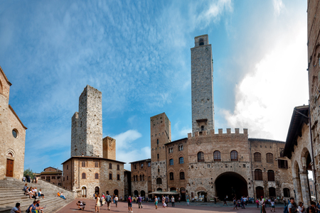 Street in walled Tuscan city of San Gimignano Italy on September il 07 2014. Tourists visit Piazza del duomo in this traditional Italian cityのeditorial素材