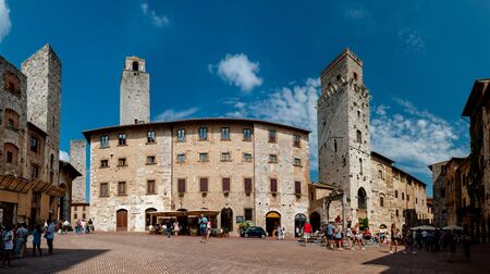 Tourists visit Piazza dela Cisterna in walled Tuscan city of San Gimignano Italy on September il 07 2014.のeditorial素材