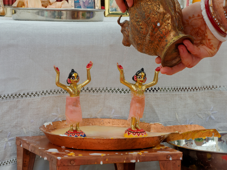 BUSHEY, JUNE 06, A devotee from Hare Krishna bathes the deities on the occasion of the feast, UK...