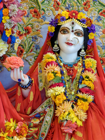 NEW MAYAPUR, AUGUST 15: Radha and Krishna in Hare Krishna temple, FRANCE, 2018. Beautifully decorated Radha deity holding a rose flower.のeditorial素材