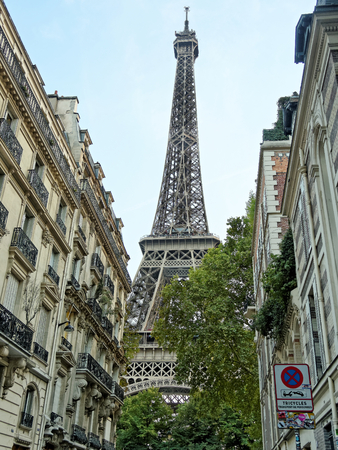 Paris, August 27: The Eiffel Tower emerging from dense urban buildings at dusk, France 2018.のeditorial素材