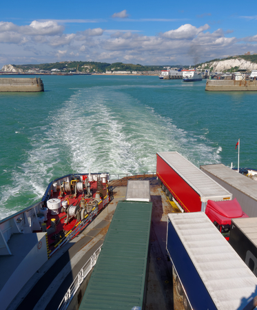 Trucks on ferry floats by English Channel on a sunny dayのeditorial素材