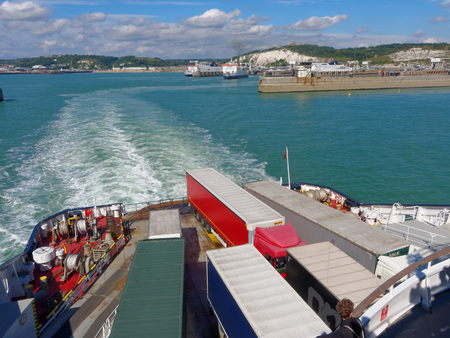 Trucks on ferry floats by English Channel on a sunny dayのeditorial素材