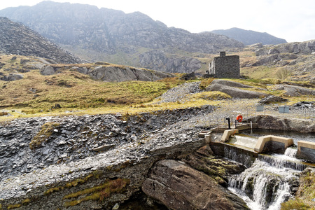 Ruins of a stone house on the Cwmorthin Waterfall trail in the mountains of Snowdonia National Park, Wales.の写真素材