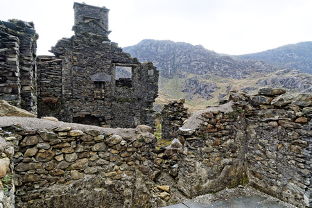 Ruins of a stone house on the Cwmorthin Waterfall trail in the mountains of Snowdonia National Park, Wales.の写真素材