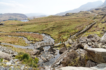 Wooden bridge on the Cwmorthin Waterfall trail in the mountains of Snowdonia National Park, Wales.の写真素材