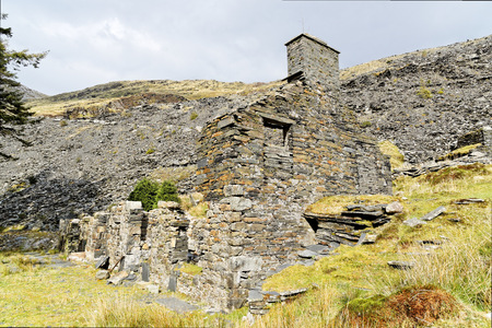Ruins of a stone house on the Cwmorthin Waterfall trail in the mountains of Snowdonia National Park, Wales.の写真素材
