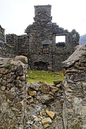 Ruins of a stone house on the Cwmorthin Waterfall trail in the mountains of Snowdonia National Park, Wales.の写真素材