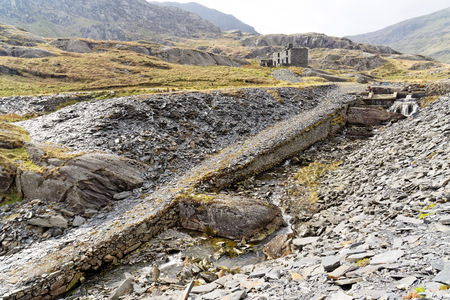 Ruins of a stone house on the Cwmorthin Waterfall trail in the mountains of Snowdonia National Park, Wales.の写真素材