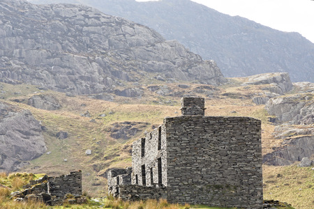 Ruins of a stone house on the Cwmorthin Waterfall trail in the mountains of Snowdonia National Park, Wales.の写真素材