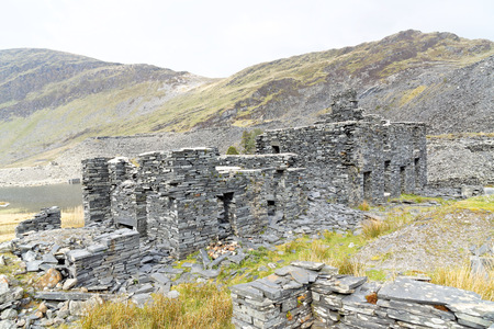 Ruins of a stone house on the Cwmorthin Waterfall trail in the mountains of Snowdonia National Park, Wales.の写真素材
