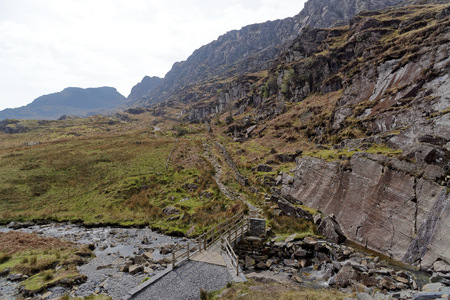 Wooden bridge on the Cwmorthin Waterfall trail in the mountains of Snowdonia National Park, Wales.の写真素材