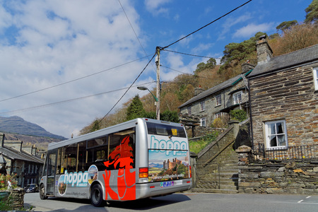 The bus passes through the village of Maentwrog in the mountains of the Snowdonia National Park, Wales, April 11, UK 2018のeditorial素材