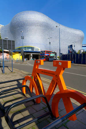 Bicycle stand and ciyt bus in front of a modernist shopping mall building., Birmingham, October 15, UK 2020のeditorial素材