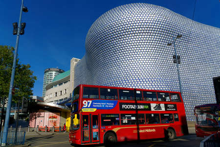 Double-decker city bus in front of a modernist shopping mall building., Birmingham, October 15, UK 2020のeditorial素材