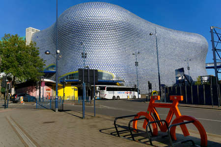 Bicycle stand and bus in front of a modernist shopping mall building., Birmingham, October 15, UK 2020のeditorial素材