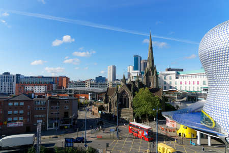 City view with the Saint Martin church and red city busesl in Birmingham, October 15, UK 2020のeditorial素材