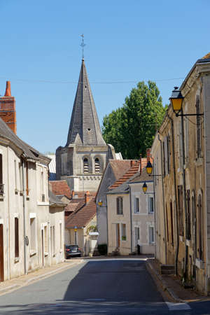 A view of a narrow street with a church tower in the small town of Ecueille, August 05, France 2020の写真素材