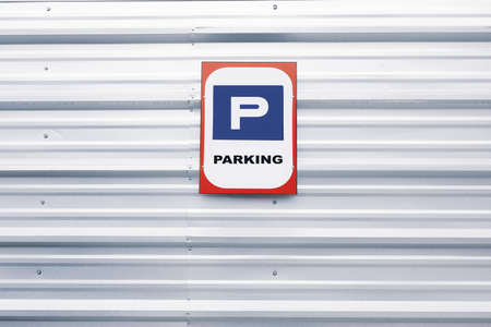 Blue parking sign on a zinc wallの写真素材