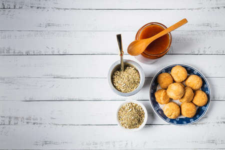 Mate, cookies and jam, over a white table. Latin Beverage. Copy space